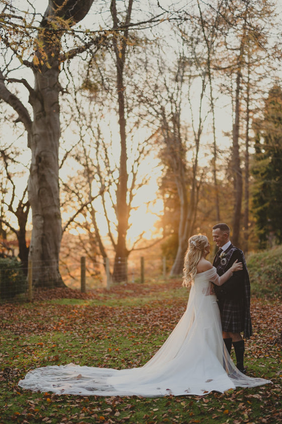 Bride and groom pose at sunset at Norwood Hall Hotel